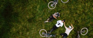 Cyclist taking a break on the meadow